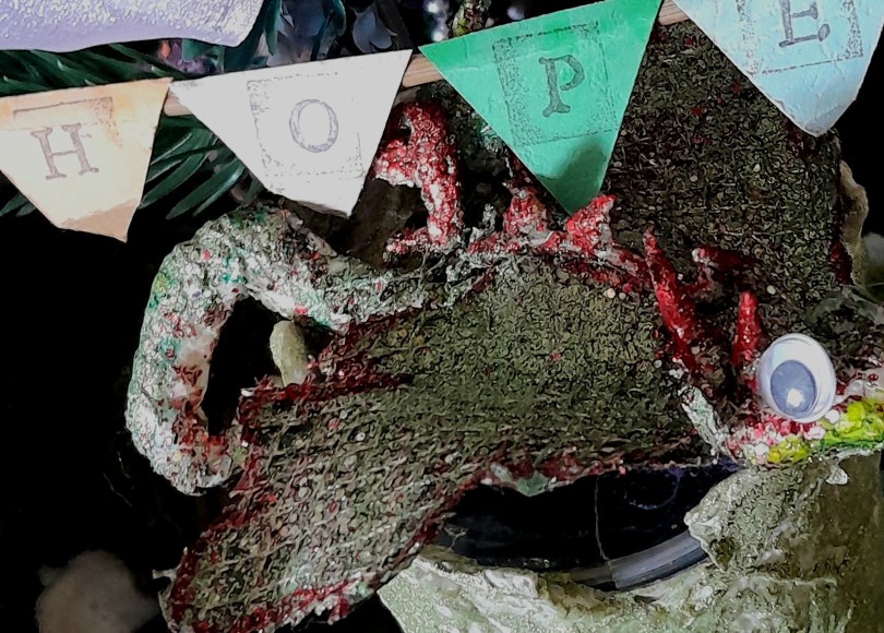 A glittery dragon under a banner reading Hope